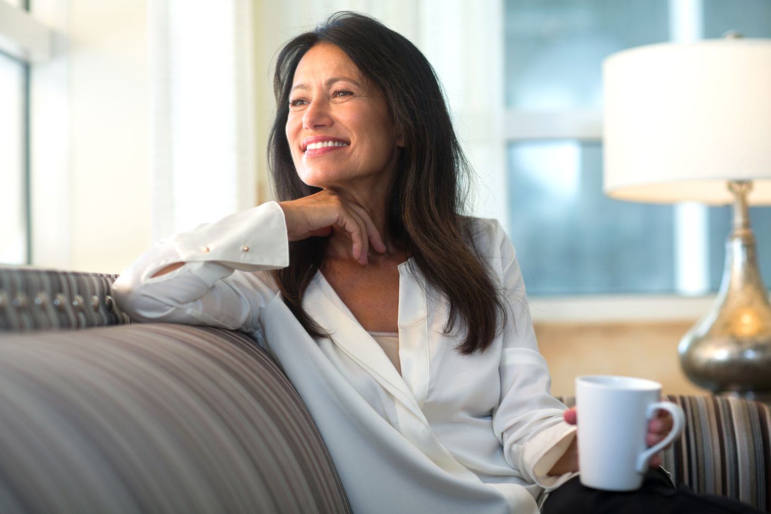 Woman on a couch with a coffee mug