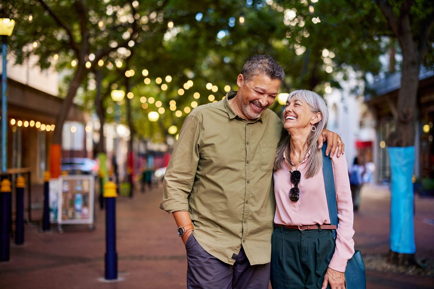 Happy couple walking in a pedestrian friendly area
